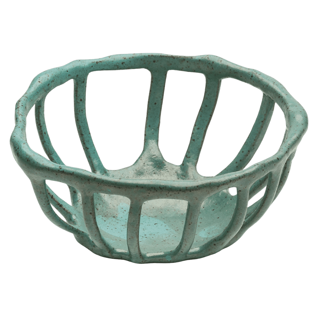 Handcrafted ceramic fruit basket with ventilated design in speckled Mexican green glaze, featuring organic openwork pattern